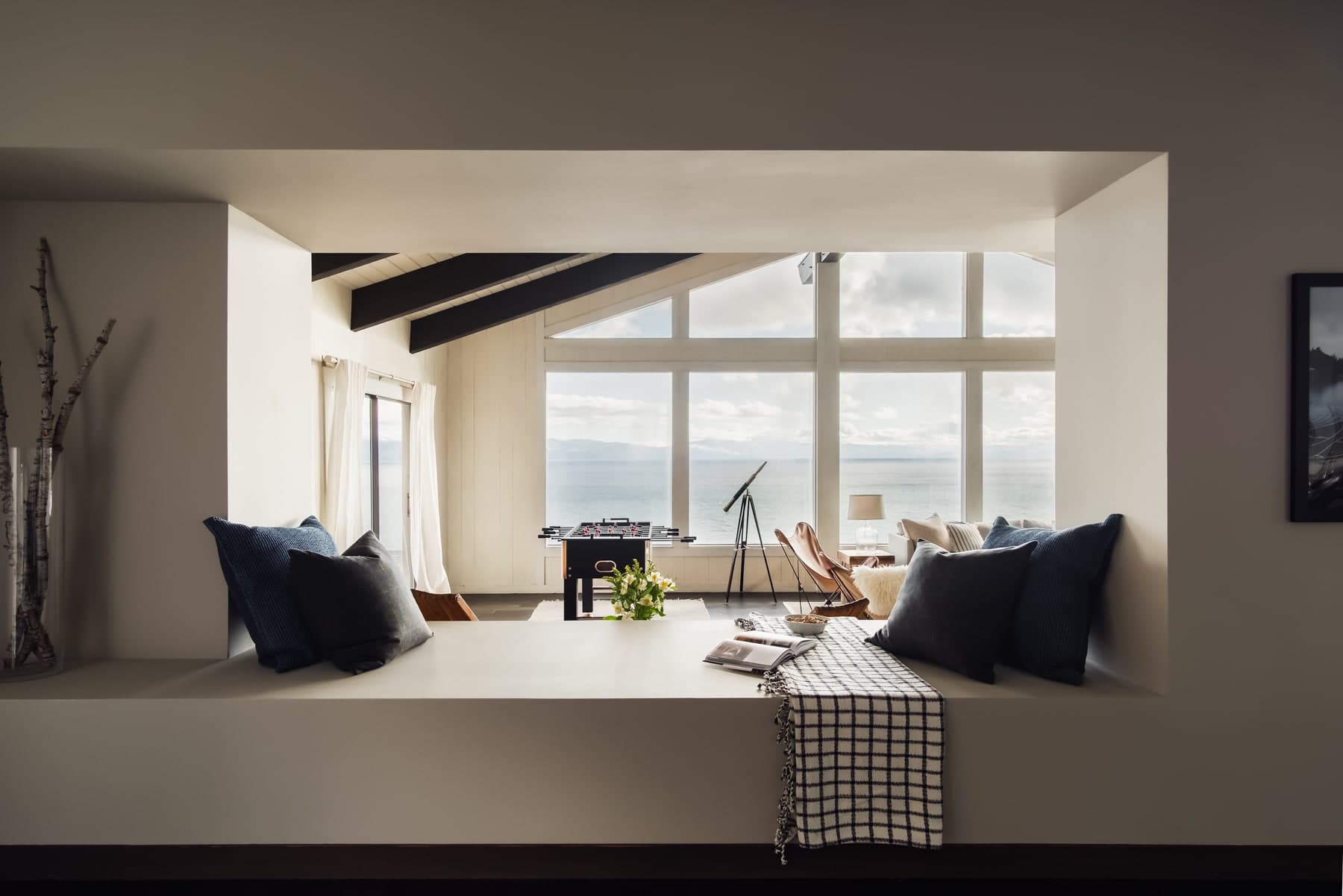 Bright Lake Tahoe living room framed by a wide interior opening and lake-facing windows